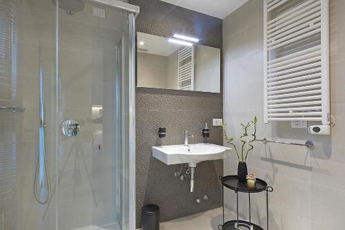 a bathroom with a sink and a shower at Ricky's Luxury Apartment in Misano Adriatico