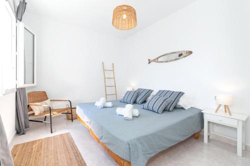 a bedroom with a bed with two stuffed animals on it at Apartamento Biniforcat 28 in Cala en Forcat