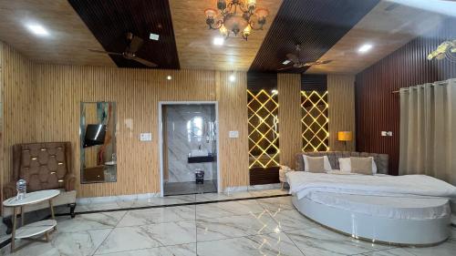 a bedroom with a large bed and a tv at Msk Hotel & Restaurant in Jāmb