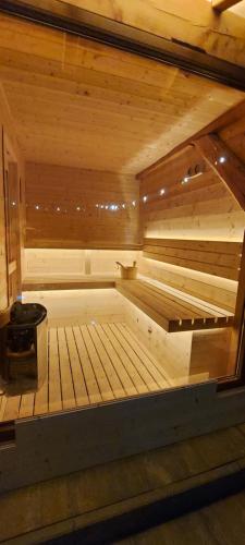a large wooden sauna with a bench in it at Casa Simion in Sibiu