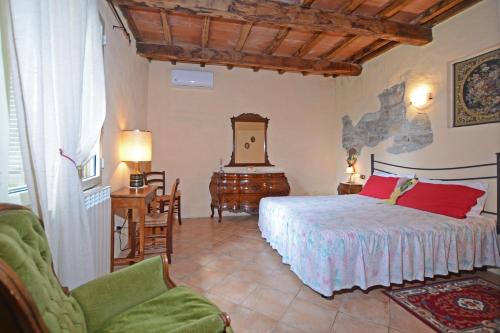 a bedroom with a bed and a table and chairs at Casale Mulino in Pancole
