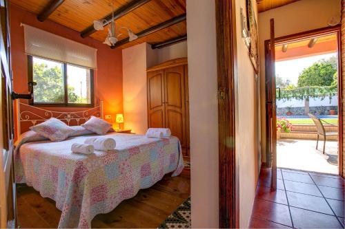 a bedroom with a bed with two towels on it at Casa Buganvilla by Vintage Travel in Órgiva