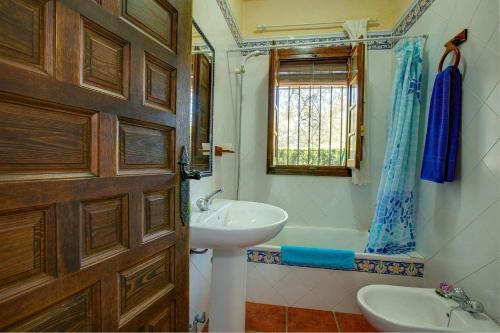 a bathroom with a sink and a bath tub at Casa Buganvilla by Vintage Travel in Órgiva