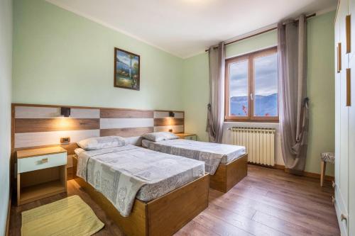 a bedroom with two beds and a window at Casa Damiano in Tremosine Sul Garda