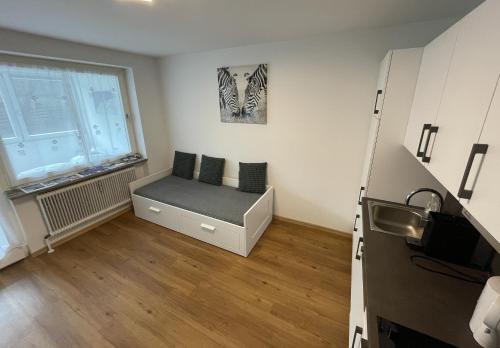 une petite pièce avec un lit et une fenêtre dans l'établissement Vidaoro Studio Flat, à Zell am See