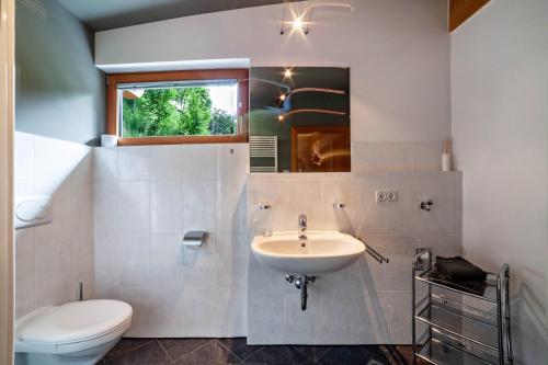 a bathroom with a sink and a toilet at Pritscheshof Ferienwohnung Balkon in Malles Venosta
