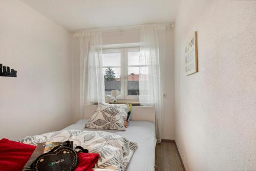 a small bedroom with a bed and a window at Ferienwohnung Griaß di in Salgen