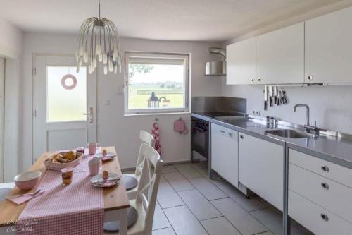 a kitchen with a table and a dining room at Ferienhaus S`bunde Heisle in Blaufelden