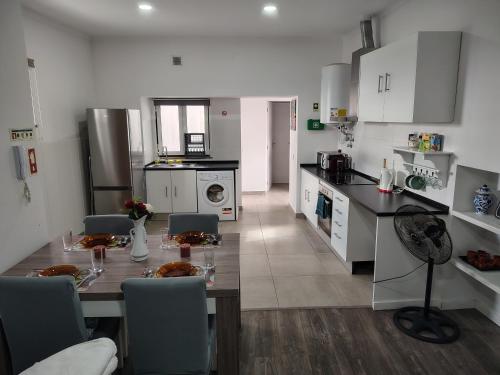 a kitchen with a table and chairs in a kitchen at Apartment in Semeador in Portalegre