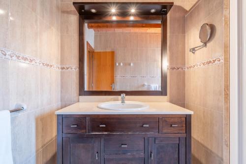 a bathroom with a sink and a mirror at Can Jaume Des Carritxó in Felanitx