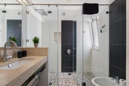 a bathroom with a shower and a sink at Villa Rose in Albufeira