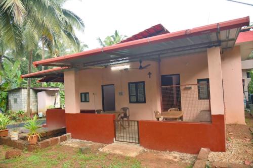a small house with a red roof at Lewis Paradise Homestay in Kalyānpur