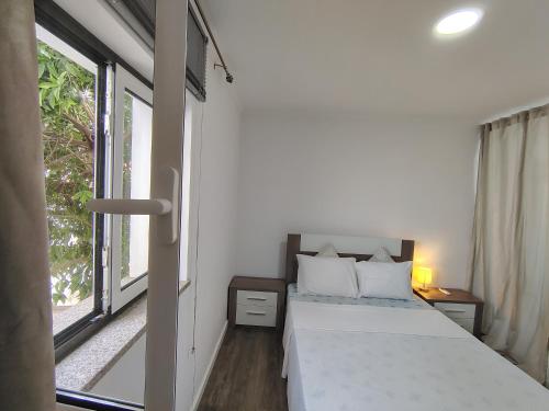 a small bedroom with a bed and a window at Apartment in Semeador in Portalegre