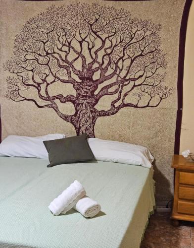 a bedroom with a tree mural on the wall at Casa Campo de tiro Gayria in Tuineje