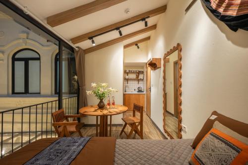 a room with a table and a balcony at Lakeside Horizon Boutique Suites-1 min to Hoan Kiem Lake-Free Airport in Hanoi