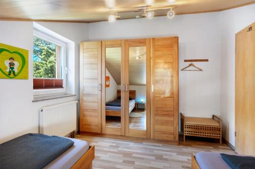 a bedroom with a sliding glass door with a bed at Ferienwohnung Beni in Öhningen