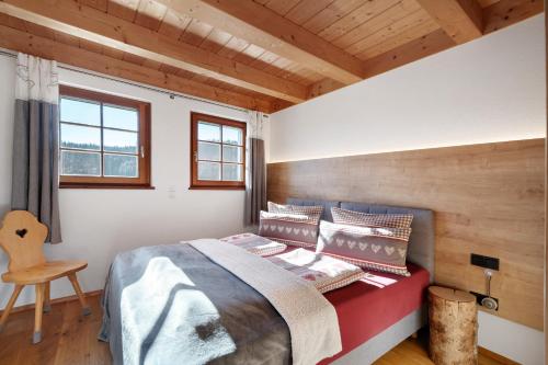 a bedroom with a bed and a wooden ceiling at Ferienwohnung Glasbläser in Lenzkirch