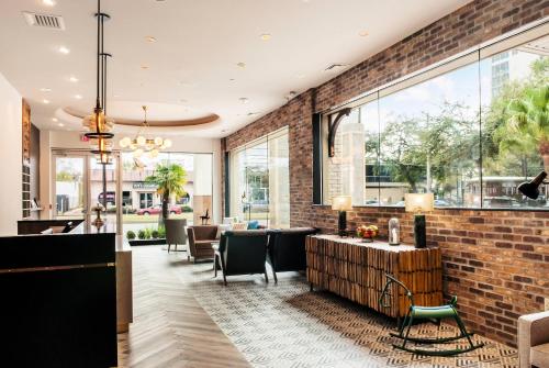 a lobby with a brick wall at St Charles Coach House, an Ascend Collection Hotel in New Orleans