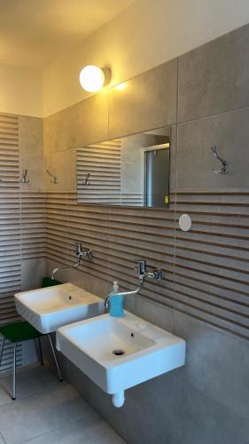 a bathroom with two sinks and a mirror at Výrovka in Pec pod Snezkou