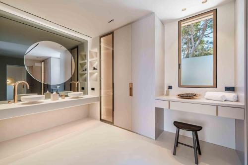 Gotmar Beach Is A Modern في إلبورت: حمام مع حوض ومرآة ومقعد