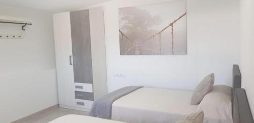a bedroom with a bed and a picture of a bridge at Casa Miramar in Frontera