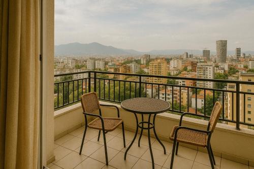 a balcony with a table and chairs and a view at Orange Rooms in Tirana