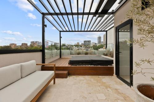 a bedroom with a bed on a balcony at City-View Retreat with Tranquil Rooftop Spa in Sydney