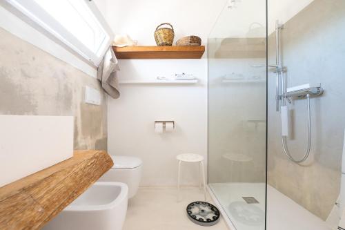 a bathroom with a shower and a toilet and a sink at Tenuta Quattro Volpi in Melendugno