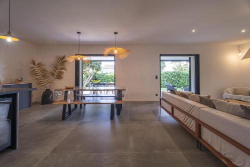 a living room with a couch and a table at Villa Malost in Hyères