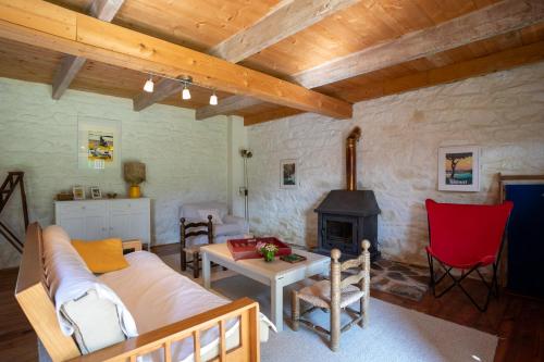 a living room with a couch and a fireplace at Longère de la Croix Blanche in Pommerit-le-Vicomte