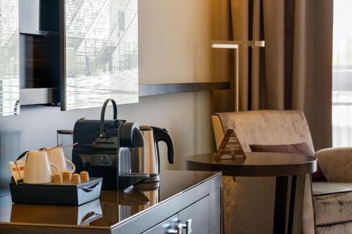 a hotel room with a coffee maker on a table at Pullman Munich in Munich