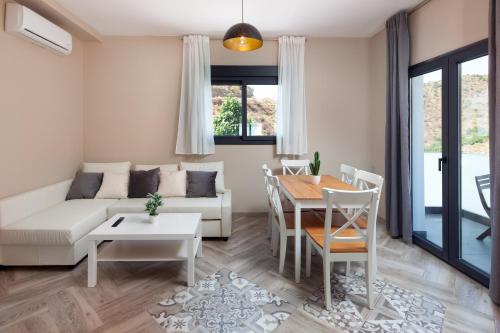 a living room with a couch and a table at Era del puerto Complejo completo in Totalán