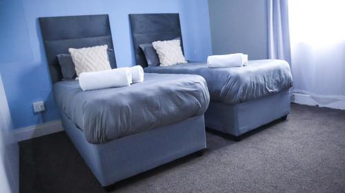 two chairs and a couch in a room at Comfy stay in East London