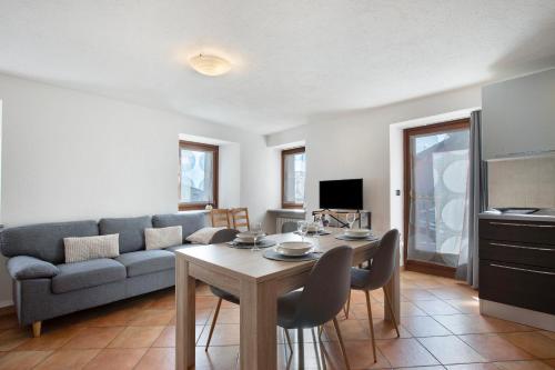 a living room with a couch and a table at Tra Montagna e Città - Aosta in Aosta