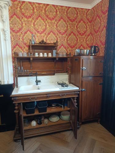 a kitchen with a sink and a counter top at Le Making Of Chambres d'Hôtes insolites et Familiales in Thairé