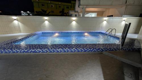 a swimming pool with lights on top of it at ALICIA HOTEL in Douala