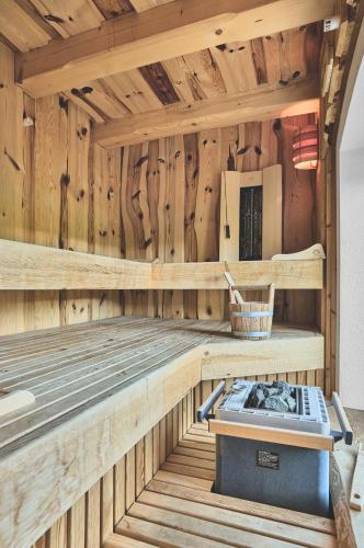 a wooden sauna with a stove in it at Chalet Bauer in Drachselsried