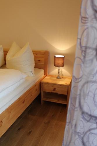 a bedroom with a bed and a lamp on a night stand at Weingartenhaus in Leutschach