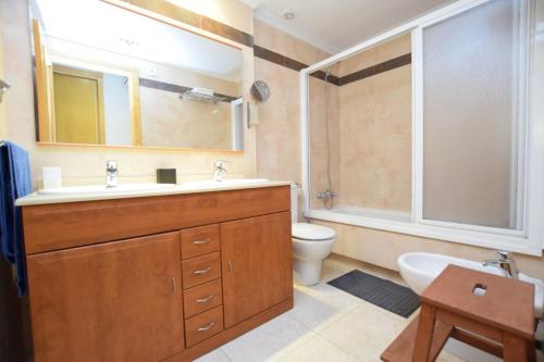 a bathroom with a sink and a toilet and a mirror at Can Tomeu in Calas de Mallorca