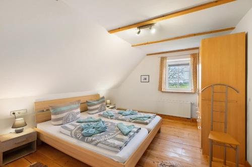 a bedroom with a large bed and a window at Galerie Haus Wohnung 3 in Sehestedt