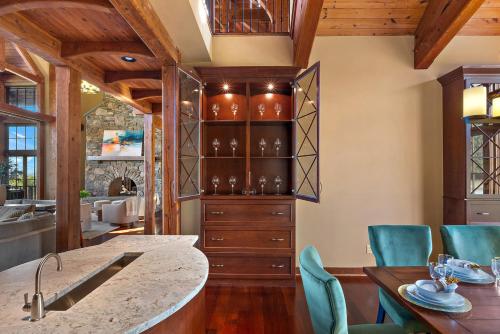 a kitchen with wooden ceilings and a dining room at Pinnacle Pointe by Relaxtay 600 Acre Private Luxury Estate with Spa, Pool, Theater and Lake in High View