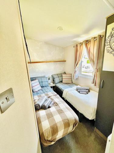 two beds in a small room with at Holiday Home with Hot Tub Cornish Country SeaSide in Newquay Bay Resort