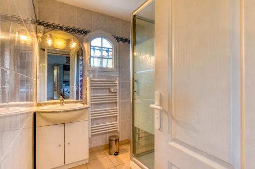 a bathroom with a sink and a shower at La Madrague St Vincent Apt A in Le Grau-dʼAgde