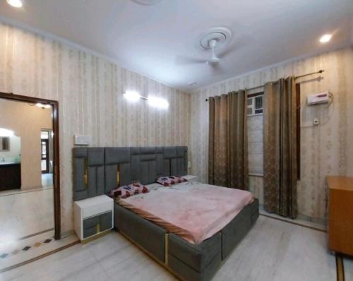 a bedroom with a large bed in a room at 2BHK Central Gurgaon in Gurgaon