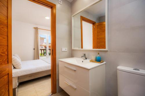 a bathroom with a sink and a mirror at Villa Paraíso in Alcudia