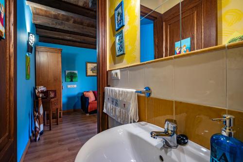 a bathroom with a sink and a mirror at Teixo in Vega de Logares