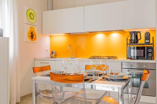 a kitchen with a table with wine glasses on it at Matera Castle Suite in Matera