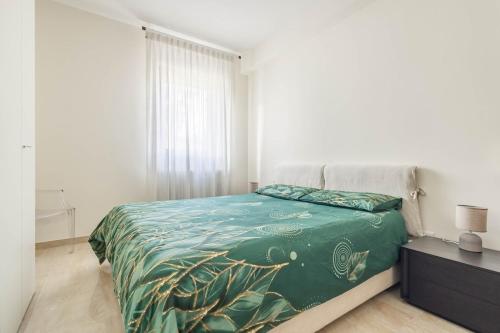 a bedroom with a bed with a green comforter at Matera Castle Suite in Matera