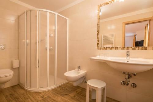 a bathroom with a sink and a toilet and a shower at Hotel Residence Gardena Alps 300 in Santa Cristina in Val Gardena