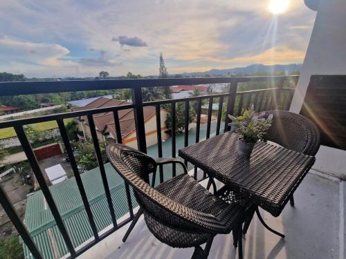 a balcony with a table and chairs on a balcony at A cozy and spacious Studio apartment Angeles city pampanga in Angeles